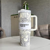 Marble-patterned tumbler with handle on a table indoors