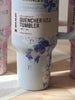 Floral-patterned tumbler with 'Stanley' branding on a wooden surface