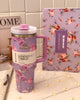 Close-up of LoveShackFancy Stanley collab tumbler showing textured matte finish and pink floral pattern on BPA-free body