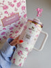 Close-up of pink bow tied to LoveShackFancy Stanley tumbler handle, emphasizing feminine aesthetic