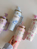 Set of floral-patterned tumblers with handles on a light background