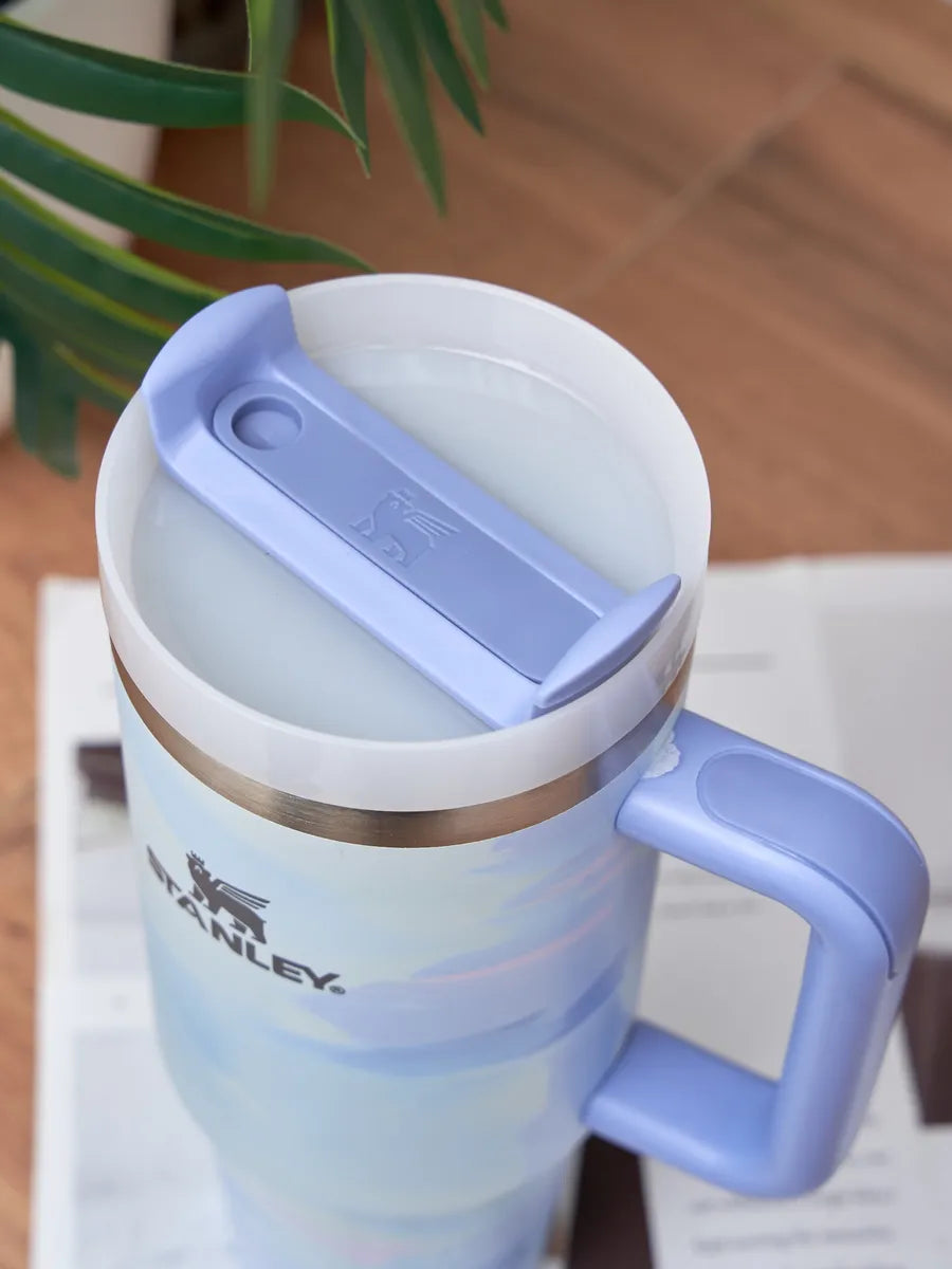 Blue Stanley mug with a white interior on a blurred background