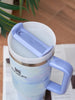 Blue Stanley mug with a white interior on a blurred background