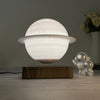 Floating Saturn Lamp in a dark room emitting a soft glow
