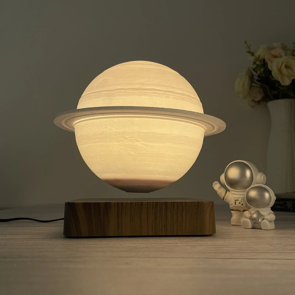 Saturn Lamp casting a warm glow on a bedside table