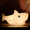 Cute shark night lamp glowing softly in children's bedroom