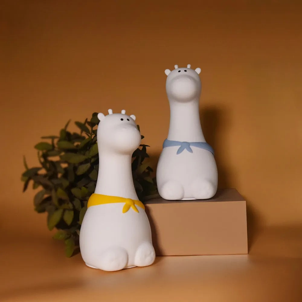 Giraffe silicone night light glowing softly in a dark room, creating a calming ambiance