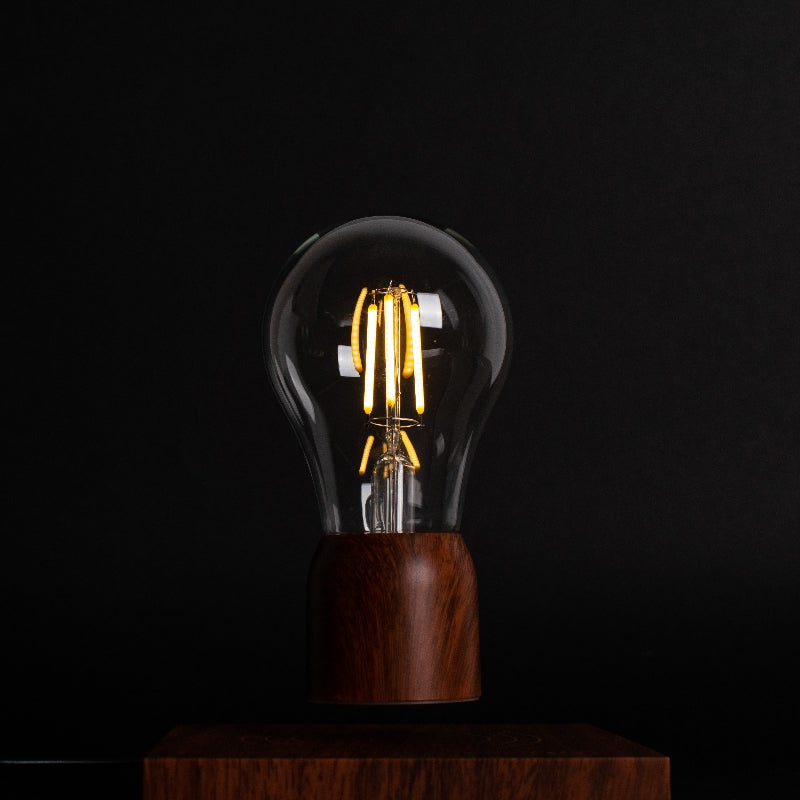 Front view of Palatial Levitating Magnetic Lamp in Mahogany finish on a desk, showcasing its elegant design and premium tone