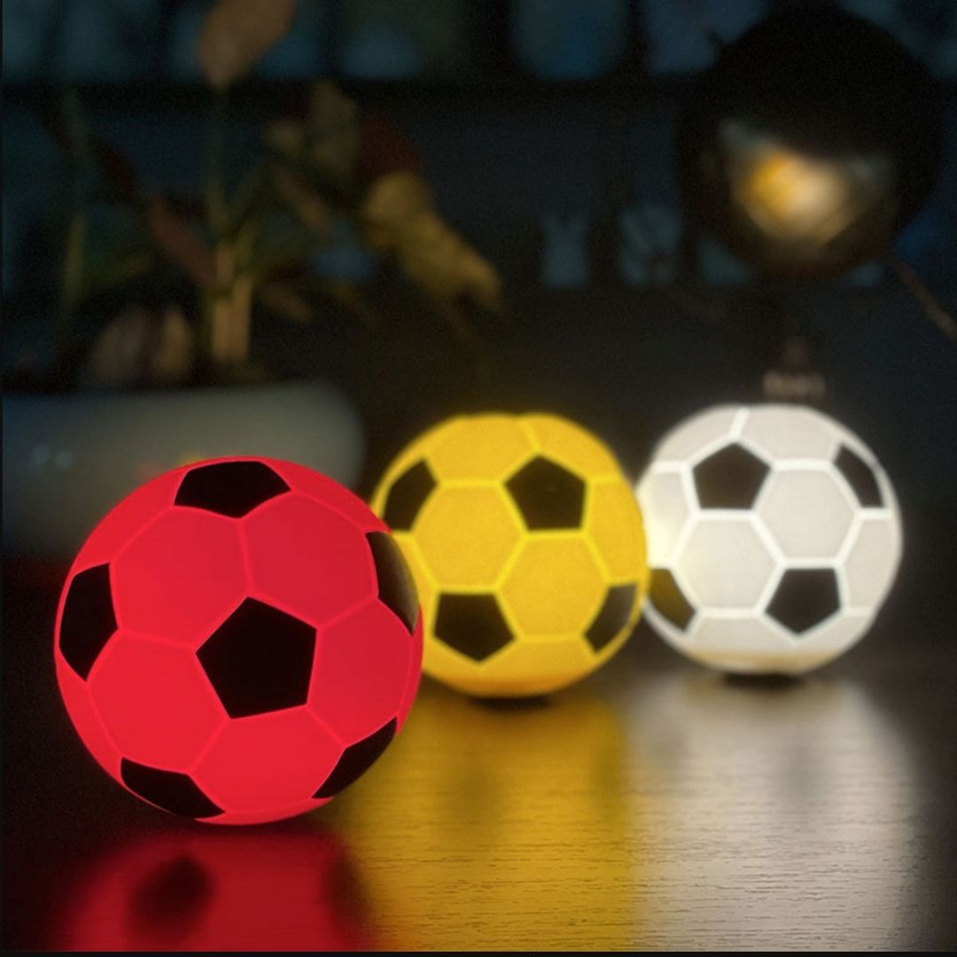 Football Silicone Night Light glowing softly in a dark room