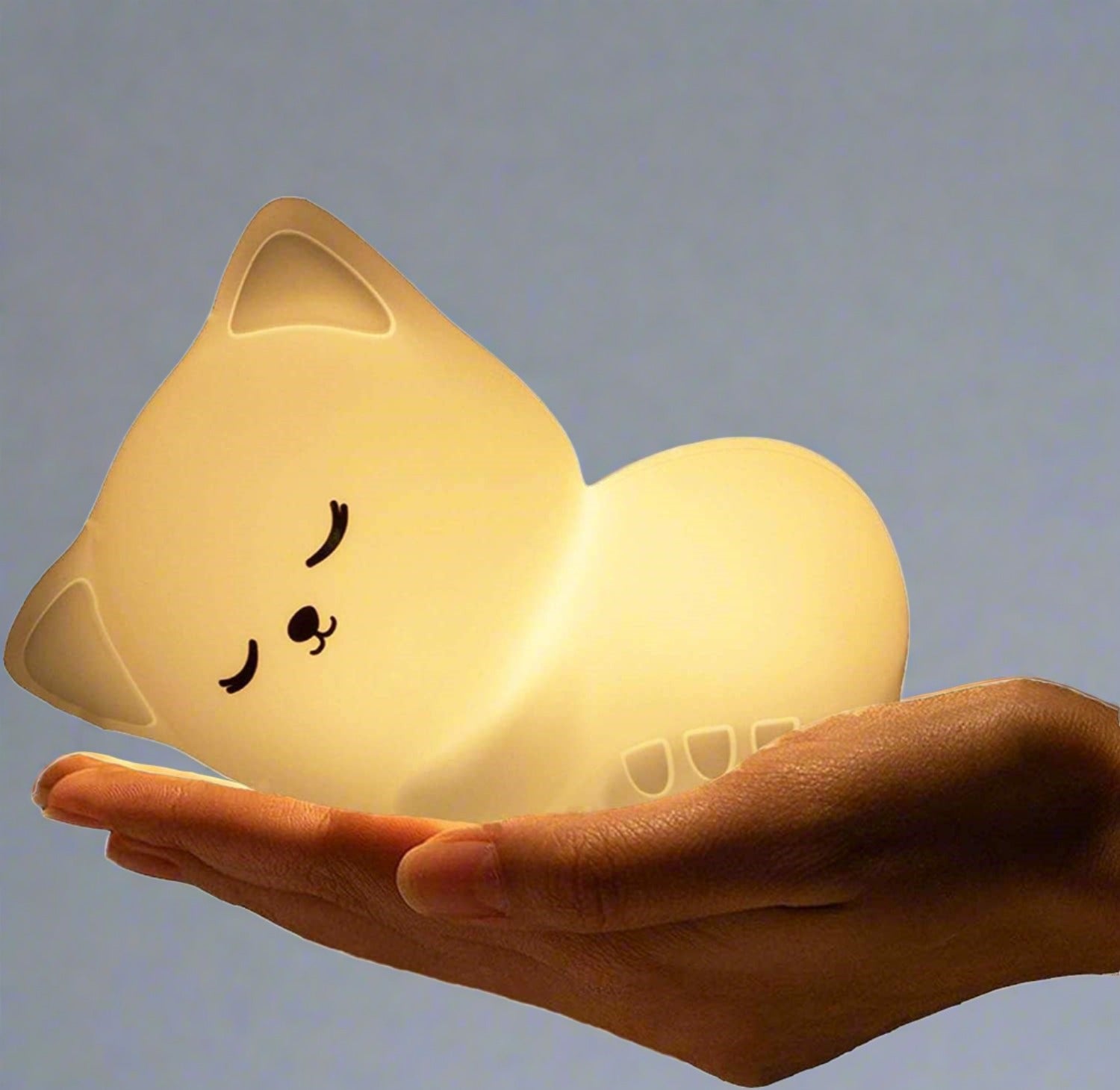 Soft silicone cat lamp emitting warm light.