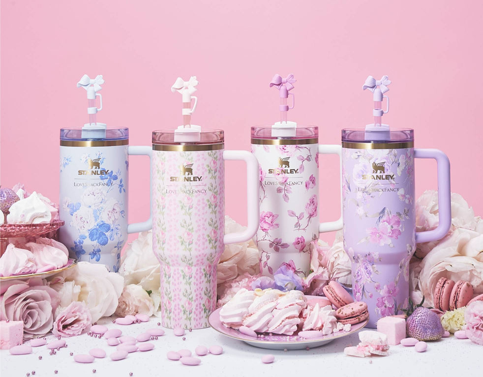 Stanley x LoveShackFancy 40 oz Quencher tumblers in four pastel floral prints – Rosa Beaux Pink, Blue, Happy Thoughts and Ribbon Rosa, with bow straw toppers